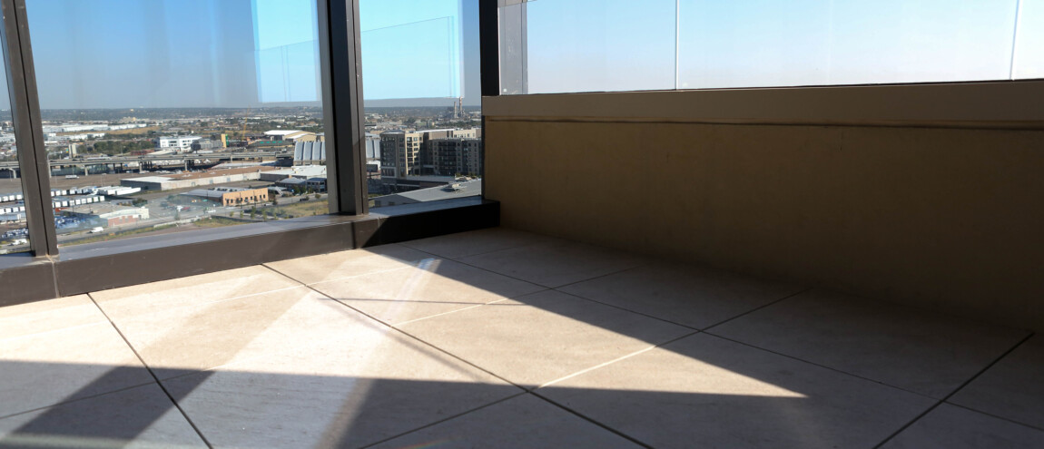 View from a balcony with tiled floor and glass railing