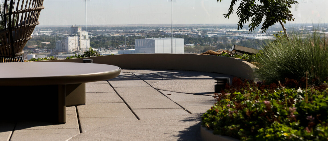 Rooftop patio with city view and modern seating.