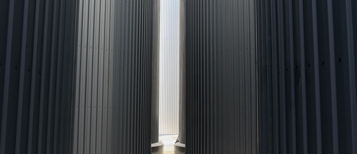 Corrugated metal silos with narrow path between them