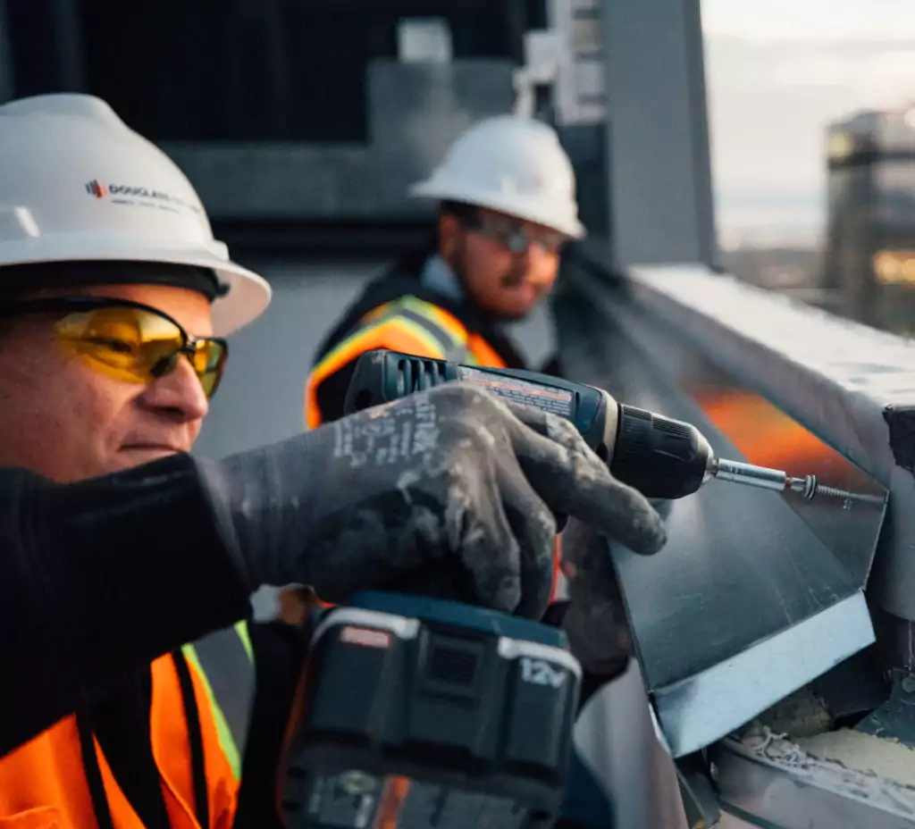 Construction worker drilling Sheet Metal