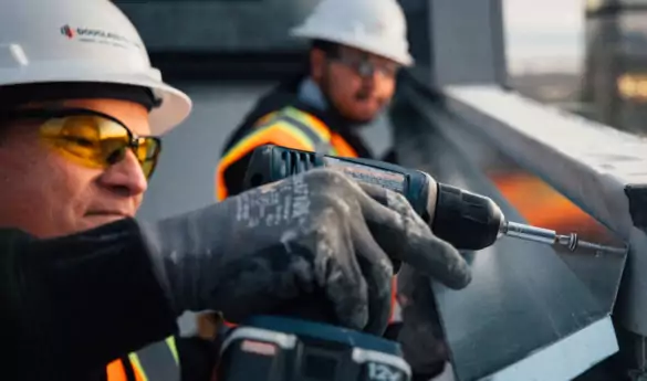 Construction worker drilling Sheet Metal