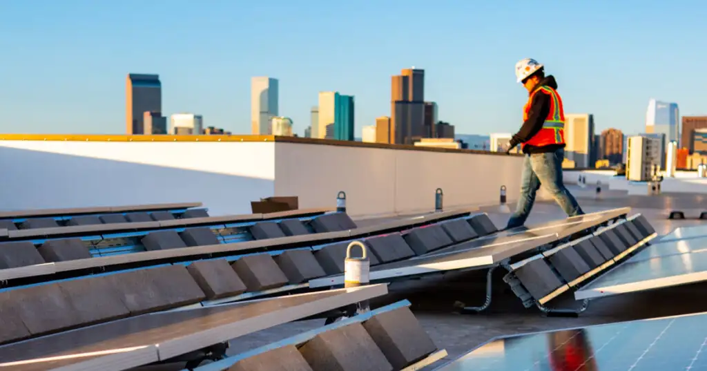 Construction worker walking on Solar panels in Downtown Denver Colorado