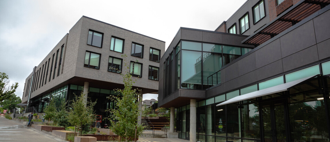 Modern building with large windows and surrounding greenery