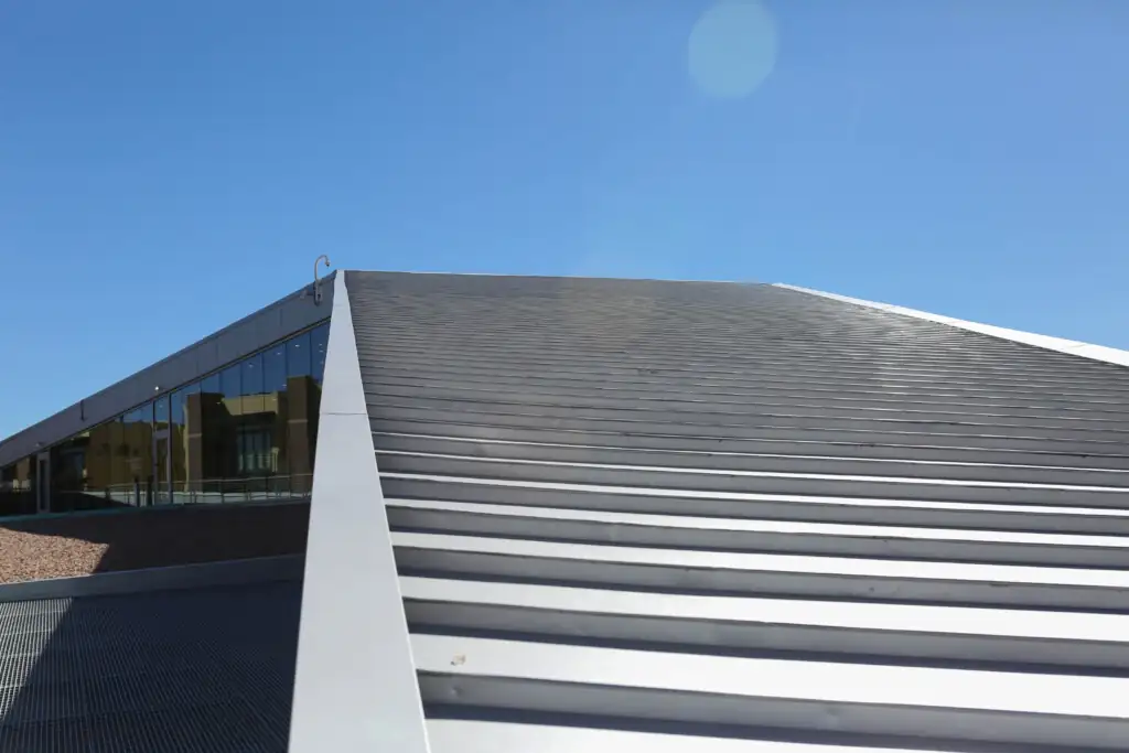 Modern metal and glass building exterior against blue sky