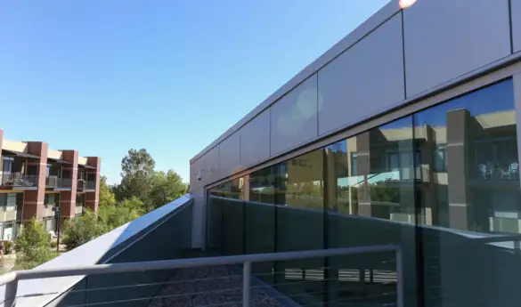 Modern building with large windows and metal railing