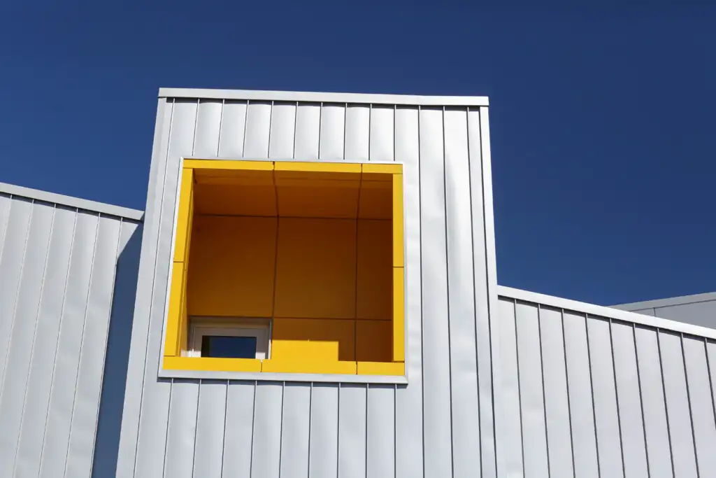 Modern building with a yellow window against blue sky