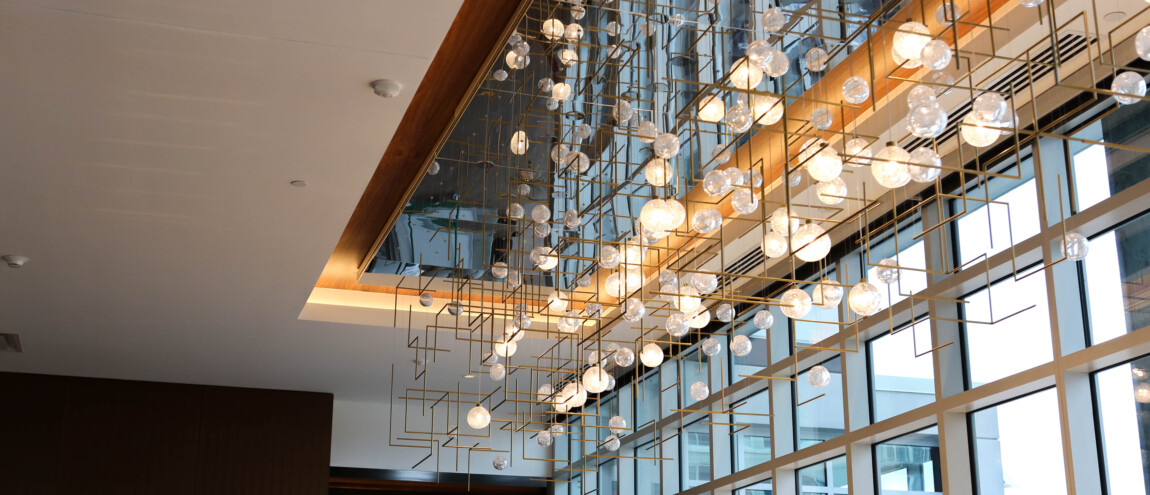 Modern chandelier with numerous glass orbs in a room