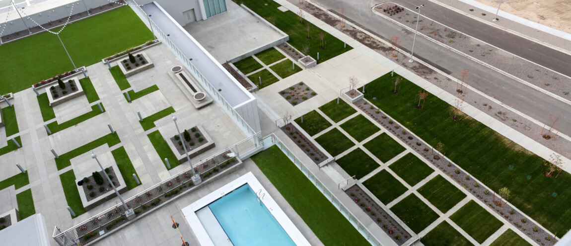 Aerial view of a modern rooftop garden and pool.