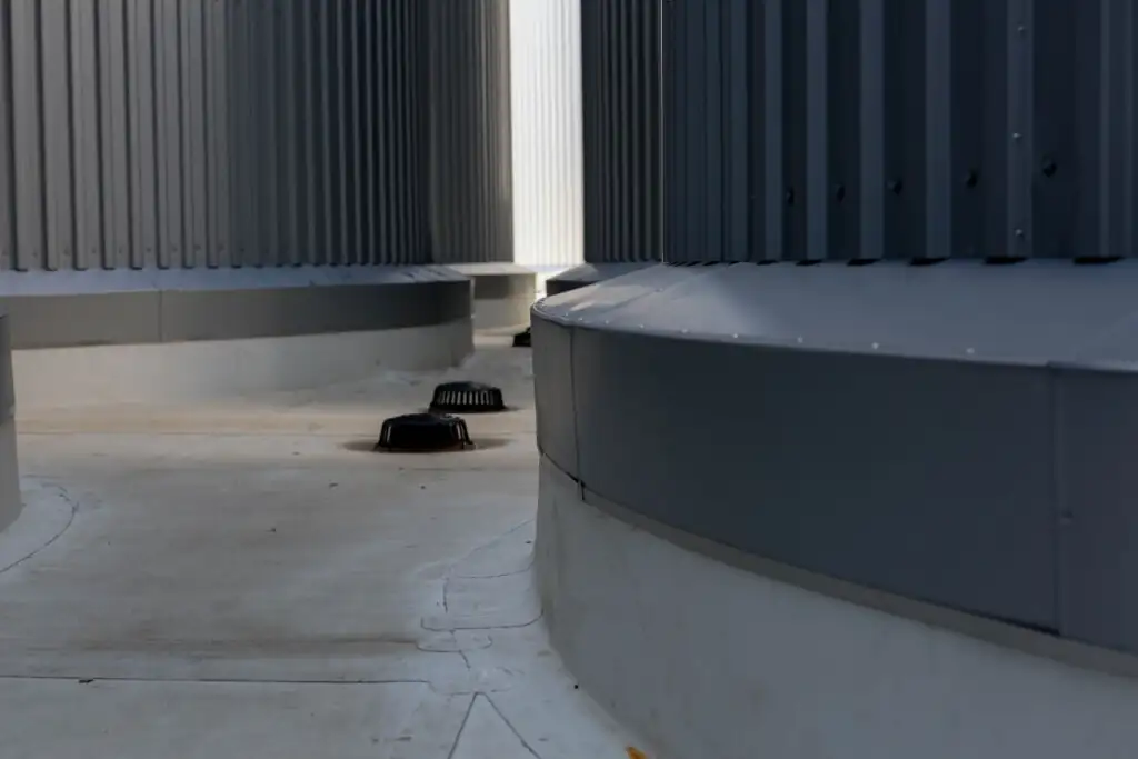 Gray industrial structure with circular vents and corrugated metal walls