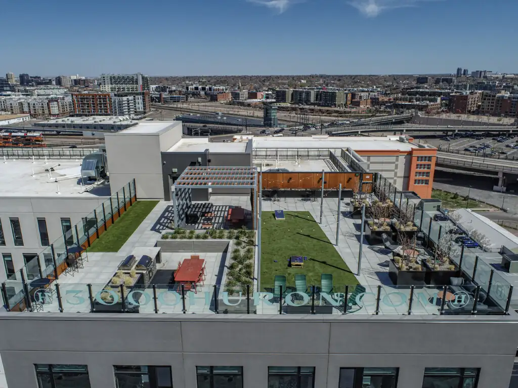 Rooftop terrace with seating, grass area, city view, 