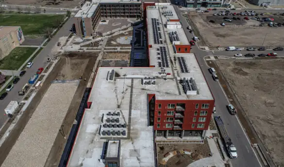 Aerial view of a construction site with red buildings