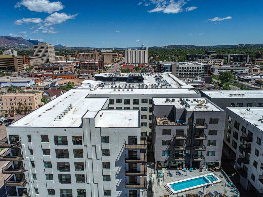 Aerial view of buildings with a rooftop pool.